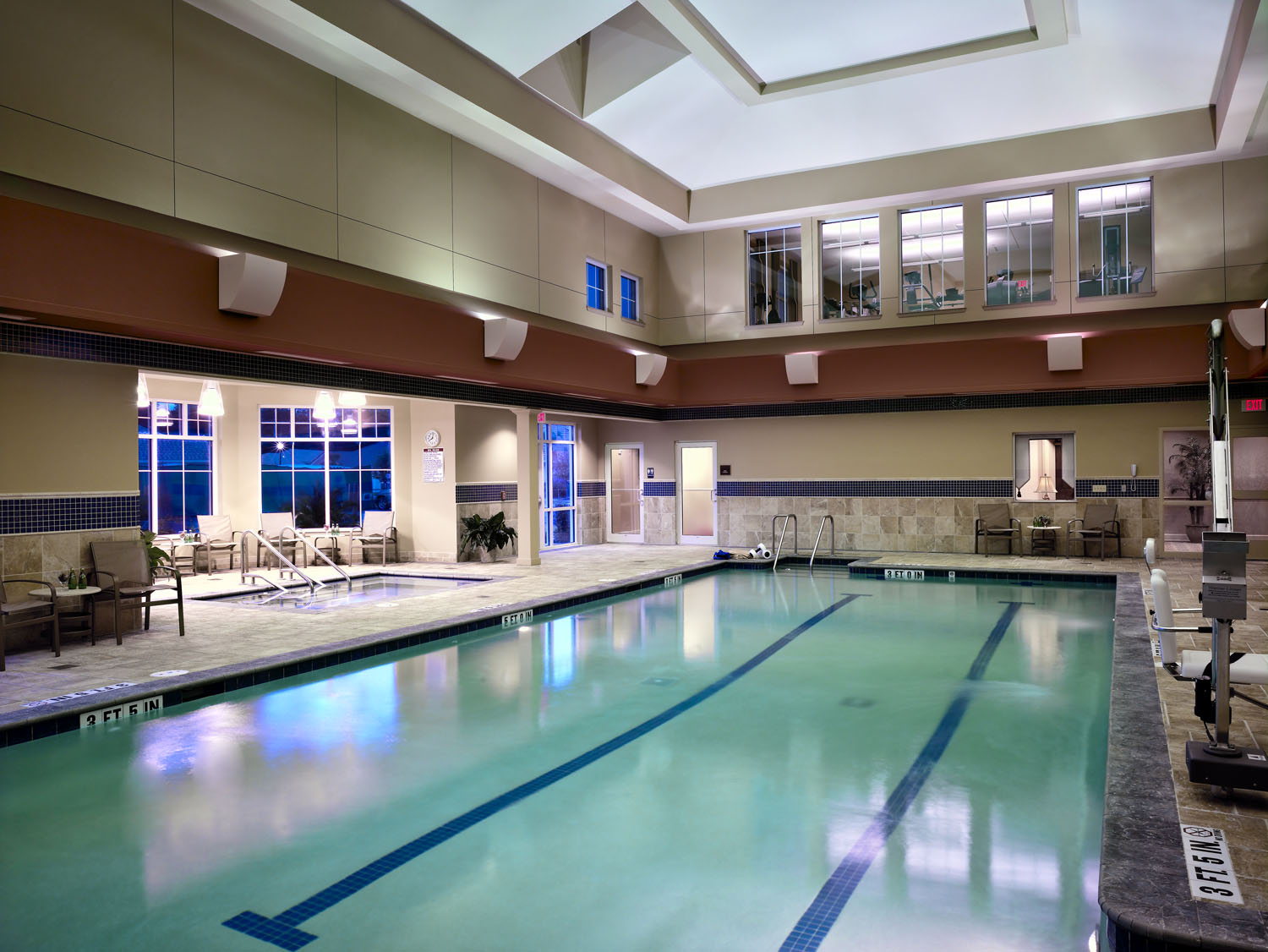 Fleet Landing pool area, a serene retreat with inviting water and comfortable lounging.