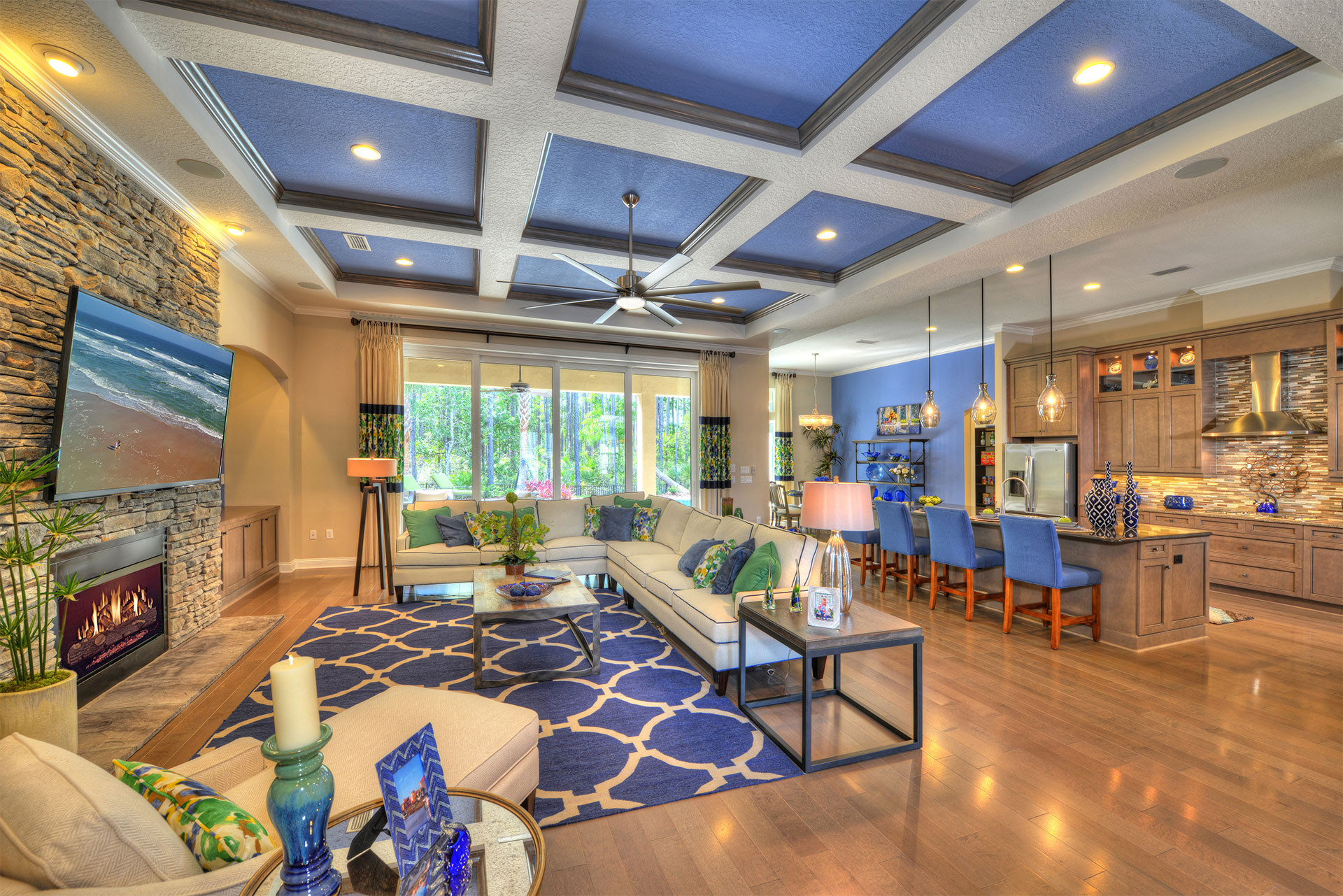 Spacious modern living room with elegant furnishings, abundant natural light, and a stylish fireplace.