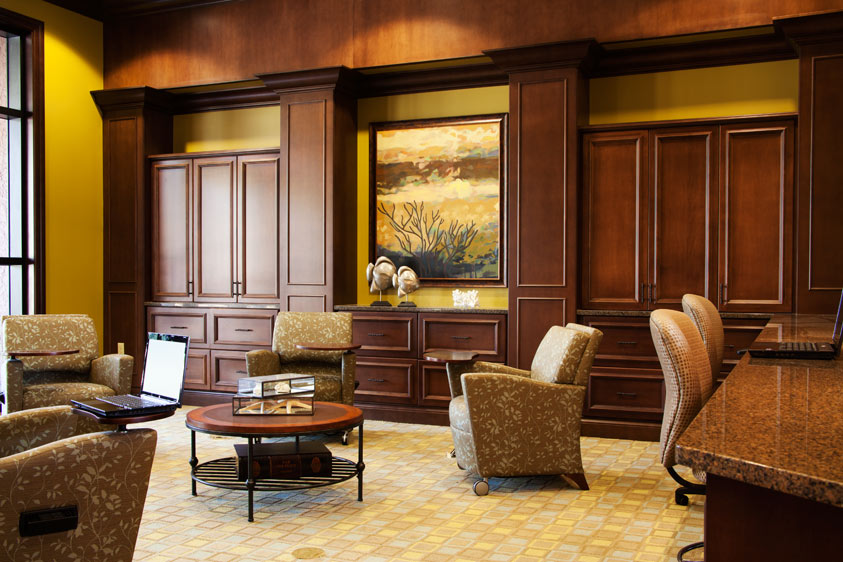 interior of a learning lounge with wooden cabinets and drawers against the wall