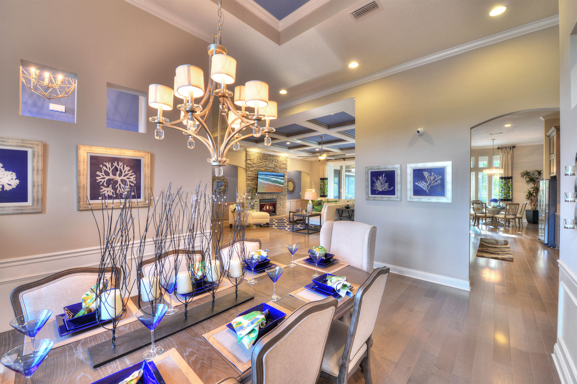 Chic dining room featuring a contemporary design with a stylish chandelier and luxurious furniture.
