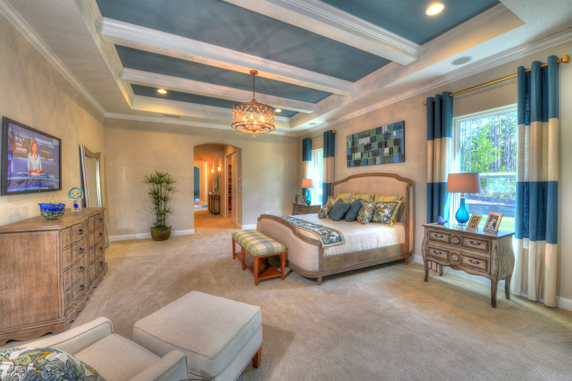 Sophisticated master suite with a tranquil ambiance, modern decor, and ample natural light.