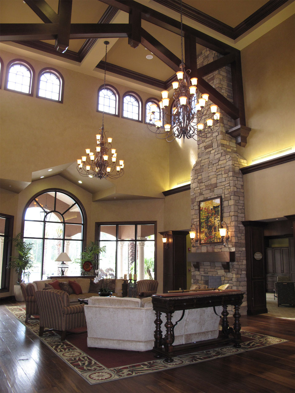 the interior of a lobby with a giant stone fireplace surrounded by couches